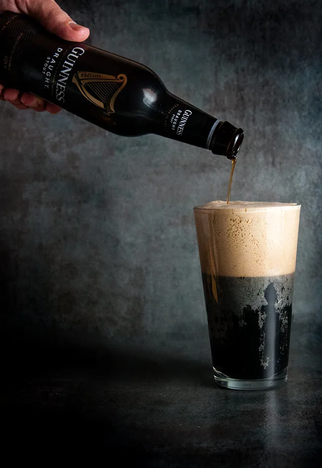 Guinness being poured into a cup