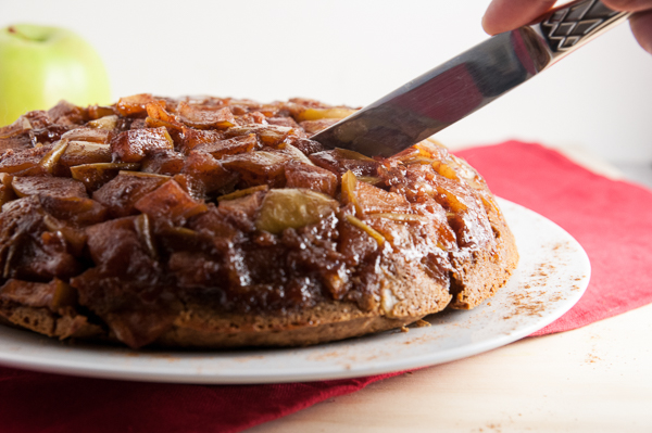 Oven Baked Apple Pancakes being cut with a knife to serve.