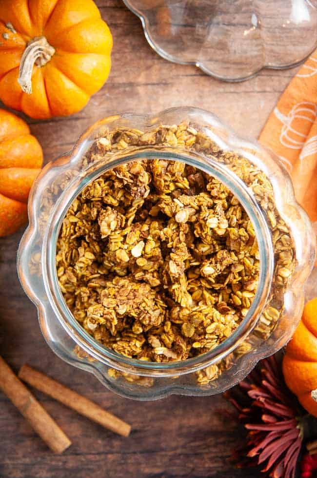 A jar of pumpkin granola on a cozy fall table