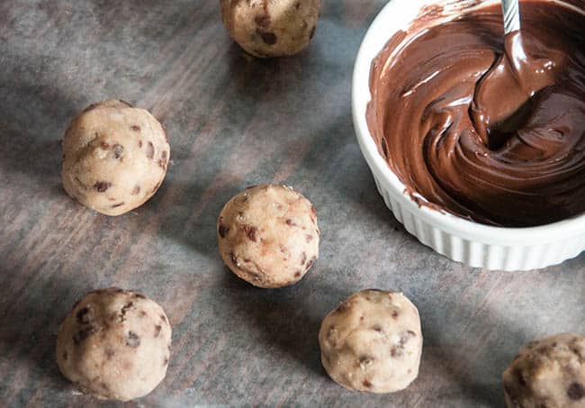 Cookie dough balls ready to be dipped in melted chocolate