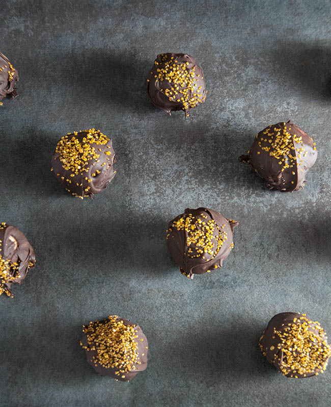 chocolate candy with gold sprinkles on gray counter