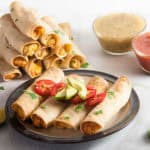 Easy Chicken Taquitos are a deliciously crunchy appetizer featuring corn tortillas, chicken and cheese and need only 5 ingredients to make. Perfect for parties, football games, or to switch up taco night!