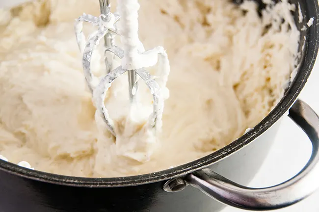 To make it easy to mash, you can briefly whip your potatoes with a hand mixer.