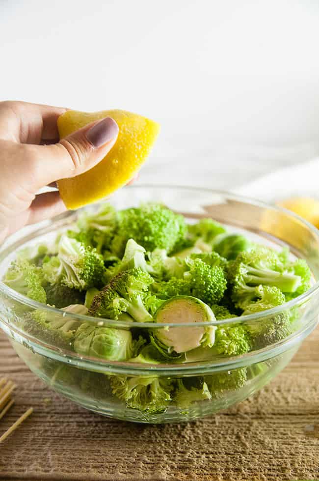 Squeezing a lemon into the veggies