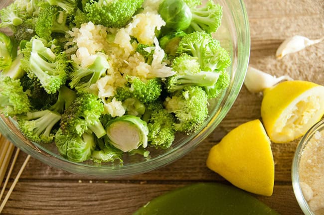 Veggies ready to be roasted with garlic, lemon, cheese, and olive oil