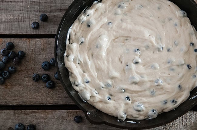 Skillet blueberry pancake batter ready to be baked