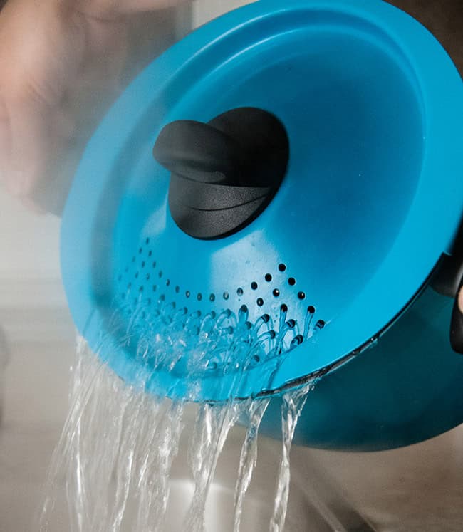 Pasta pot draining water over sink