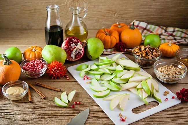 All the ingredients for an apple and pear kale salad with maple Dijon vinaigrette