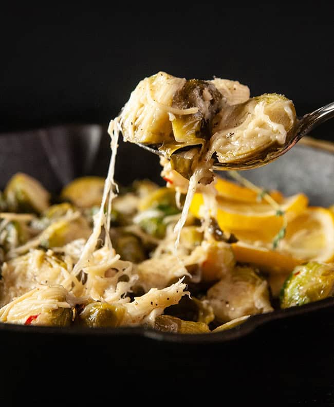 A cheese pull on black with Roasted Garlic Parmesan Brussel Sprouts