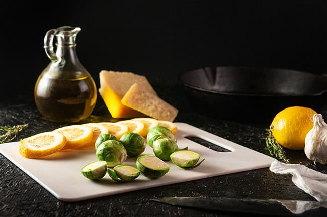 Trim the ends of the brussel sprouts and chop them in half.