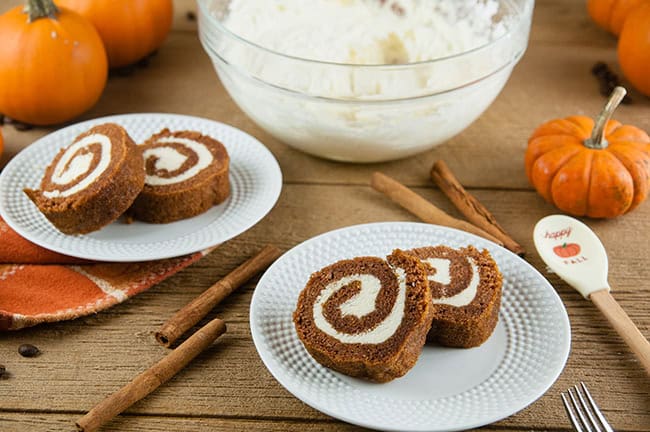 Boozy Pumpkin Spice Buttercream inside pumpkin rolls on wood