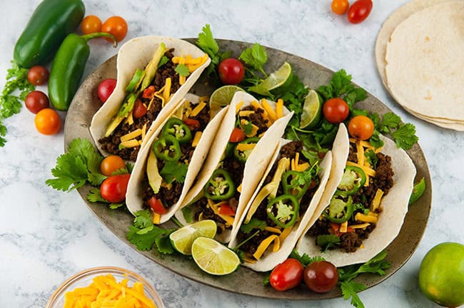 Platter of tacos on light background