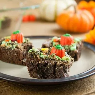 Plate with 3 pumpkin patch brownies on wood