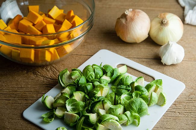 Chopped Brussels Sprouts and Butternut Squash and onions on wood