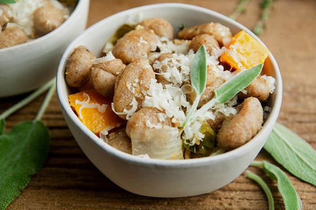 Roasted Sheet Pan Gnocchi and Fall Vegetables in a bowl on wood