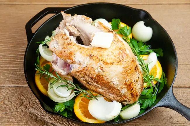 Get the turkey ready for the oven with more butter, olive oil, herbs, and aromatics
