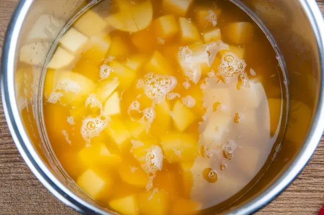 potato cubes in vegetable broth in the liner of the Instant Pot