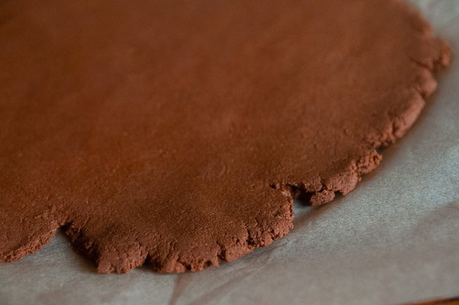 dough rolled out on parchment paper