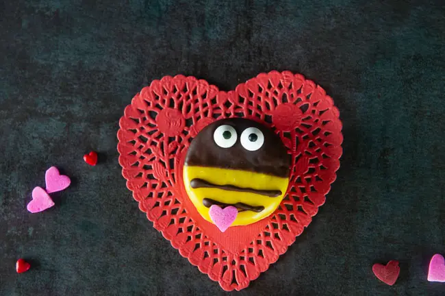 bumblebee cookie on red heart on black