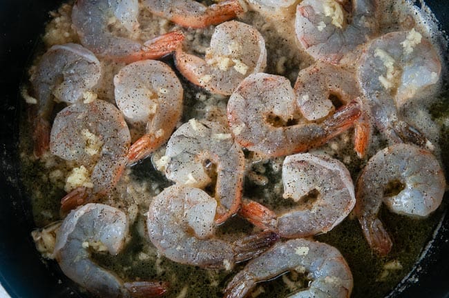 shrimp cooking in a cast iron pan