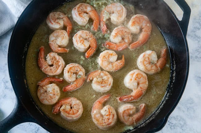 Shrimp scampi cooking in a skillet