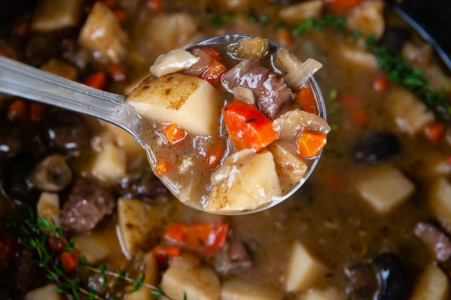 A ladle full of cozy Dutch Oven beef stew