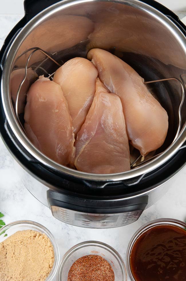 Ingredients for Instant Pot Barbecue Chicken: Chicken, spices, brown sugar, barbecue sauce, and water