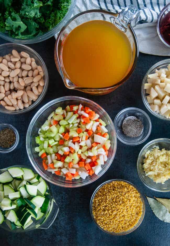 Ingredients for Instant Pot Minestrone Soup: white beans, zucchini, carrots, onions, celery, garlic, potatoes, pasta, vegetable broth, garlic, Italian seasoning, tomato paste and lemon juice