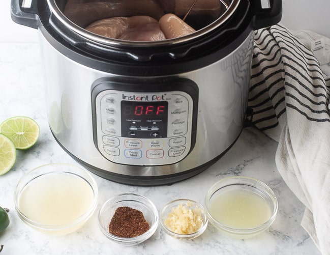Ingredients for Instant Pot Chicken Tacos: chicken, chicken stock, spices, garlic and lime juice