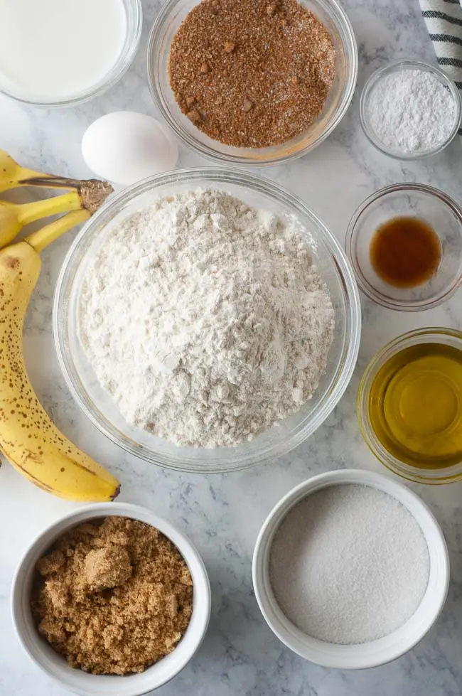 Ingredients for Cinnamon Swirl Banana Bread: overripe bananas, brown and white sugar, baking powder, salt, vanilla, milk, oil, an egg and cinnamon
