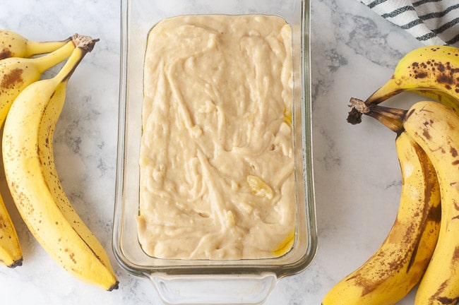 Spread half the banana bread batter out evenly in a loaf pan
