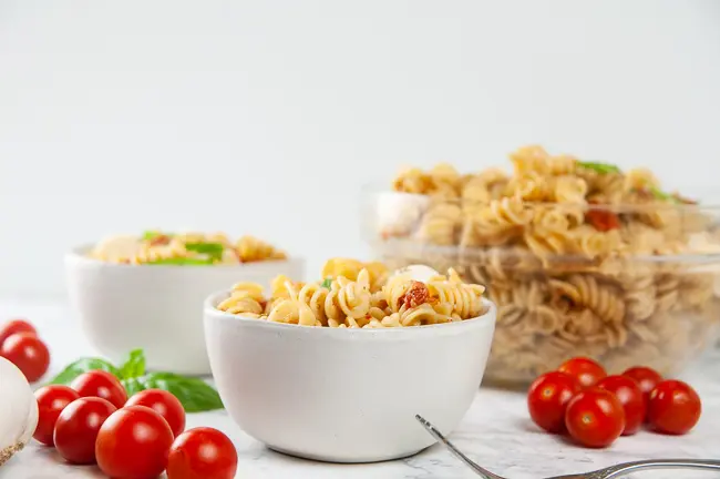 Instant Pot Caprese Pasta is delicious hot or cold served as Caprese pasta salad