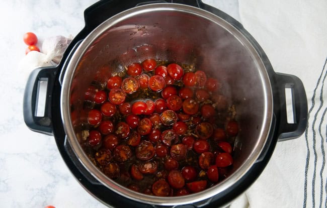 Add the tomatoes, garlic, seasoning and balsamic to olive oil