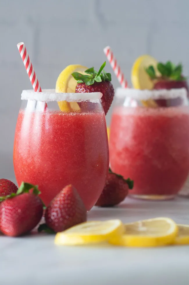 Boozy strawberry lemonade slushies make a fun drink for summer.