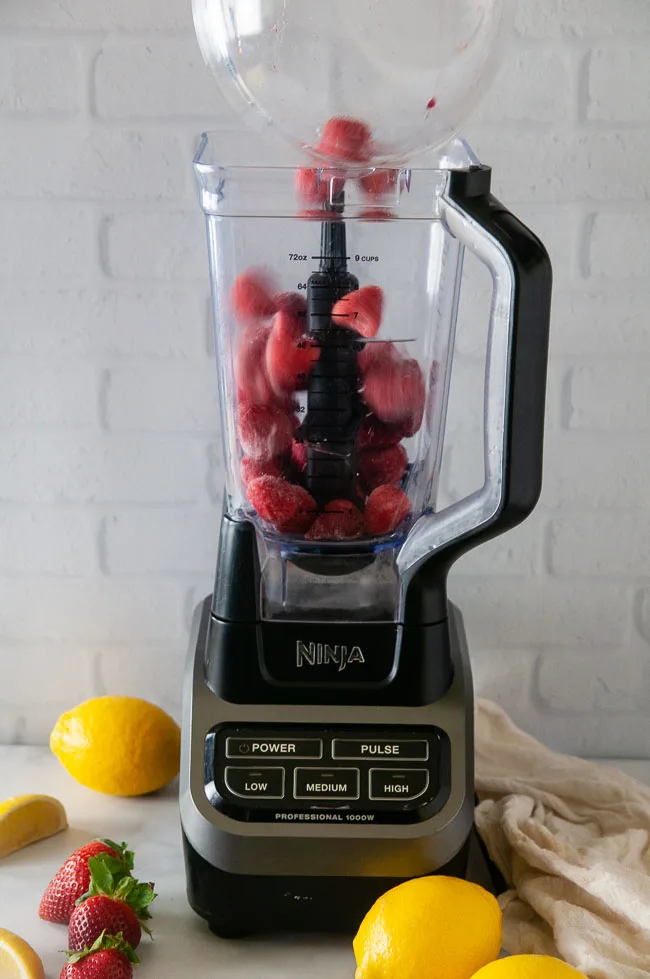 Add the frozen strawberries to your blender