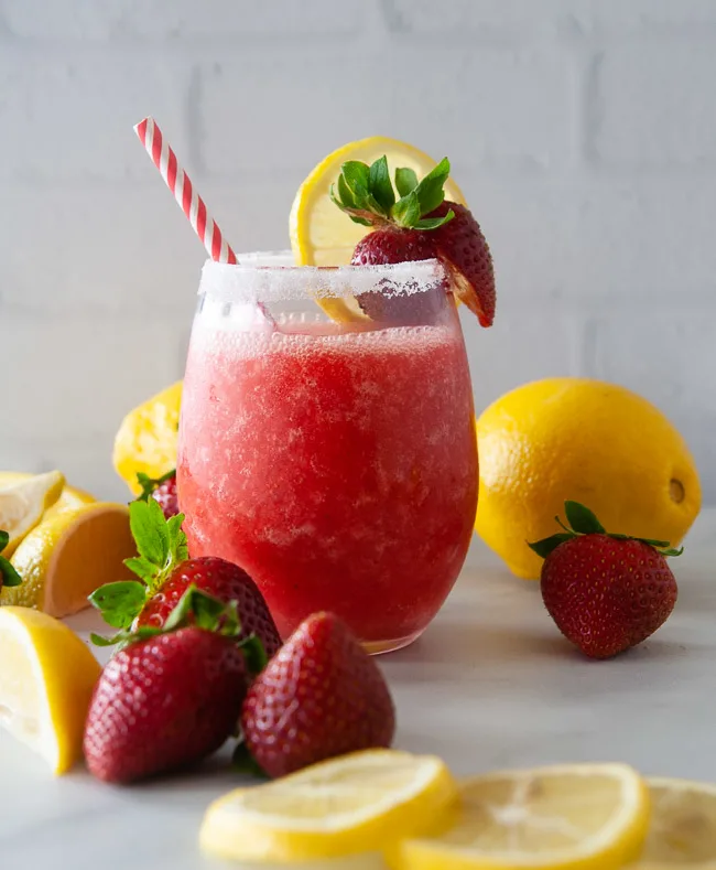 Boozy strawberry lemonade slushies make a fun drink for summer.