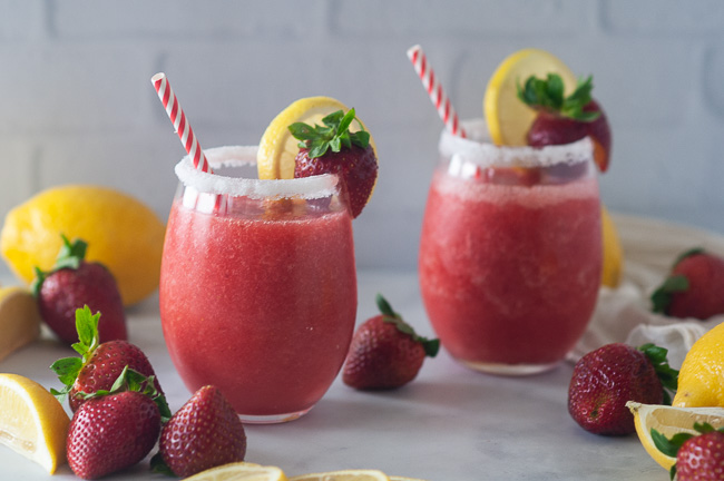 Boozy strawberry lemonade slushies make a fun drink for summer.