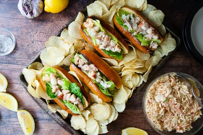 Potato chips and coleslaw pair well with lobster rolls.