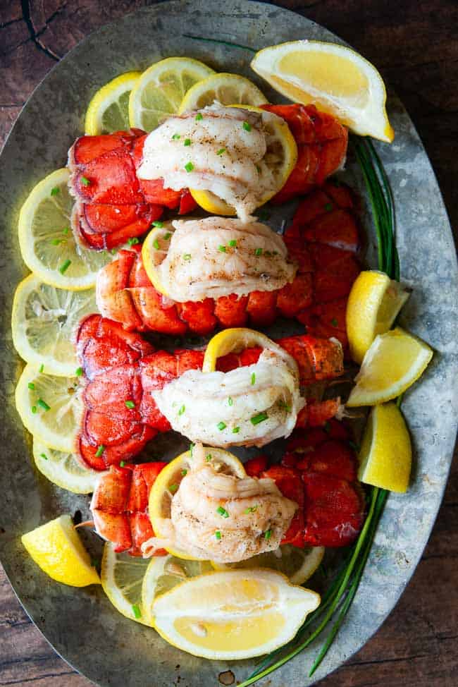 Learn How to Cook Lobster Tail Like a Pro! 4 lobster tails ona platter.