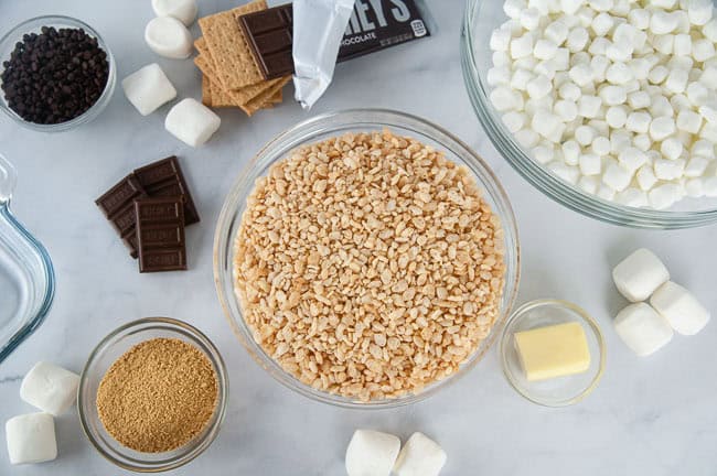 Ingredients for S'mores Rice Krispie Treats: Marshmallows, butter, Rice Krispies, graham cracker crumbs and chocolate chips