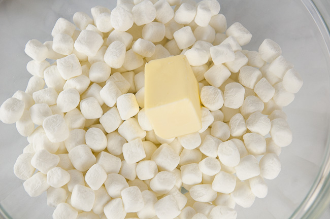 Add the marshmallows and butter to a microwave safe bowl.