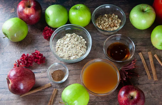 Ingredients for Instant Pot Stuffed Apples: Apples, Rolled Oats, Spices, Maple Syrup, Apple Cider, and Walnuts