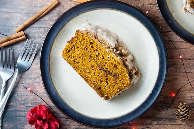 Cinnamon Swirl Pumpkin Bread with Streusel Topping sits on a brown rimmed plate waiting to be eaten!