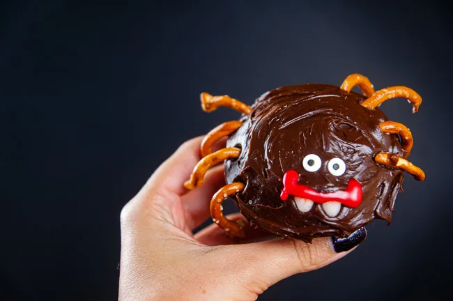 Decorate the cupcake to look like a spider with candy eyes, candy corn pieces, decorator gel and pretzels.