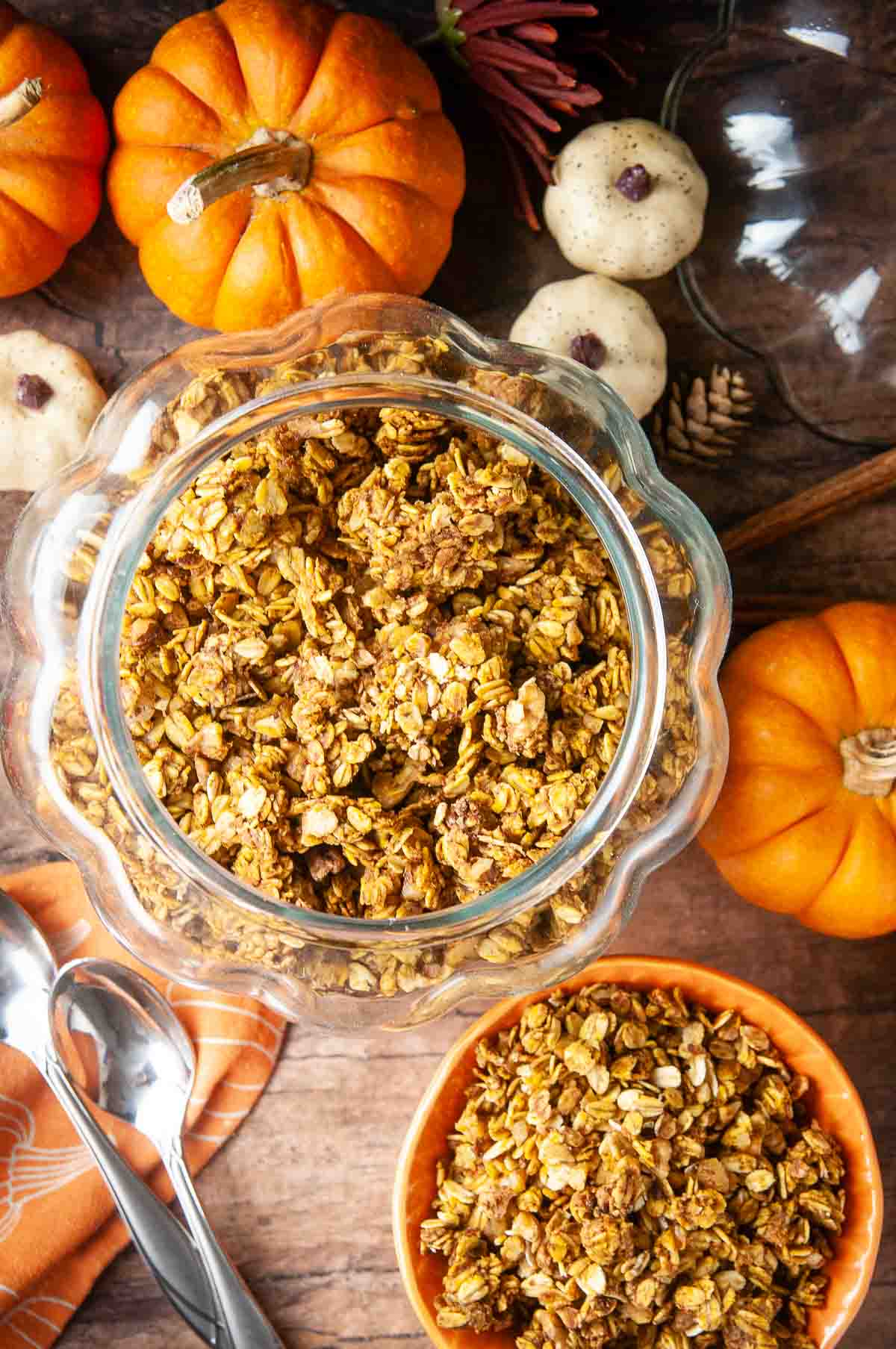 A glass pumpkin jar stores this homemade pumpkin granola so you can feel festive while you spoon it out into your orange cereal bowl.