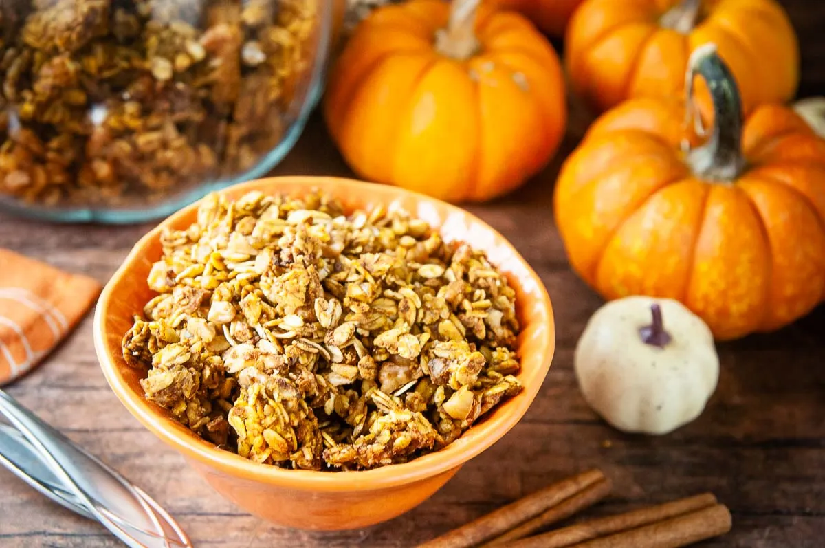 A bowl of pumpkin granola on a cozy fall table