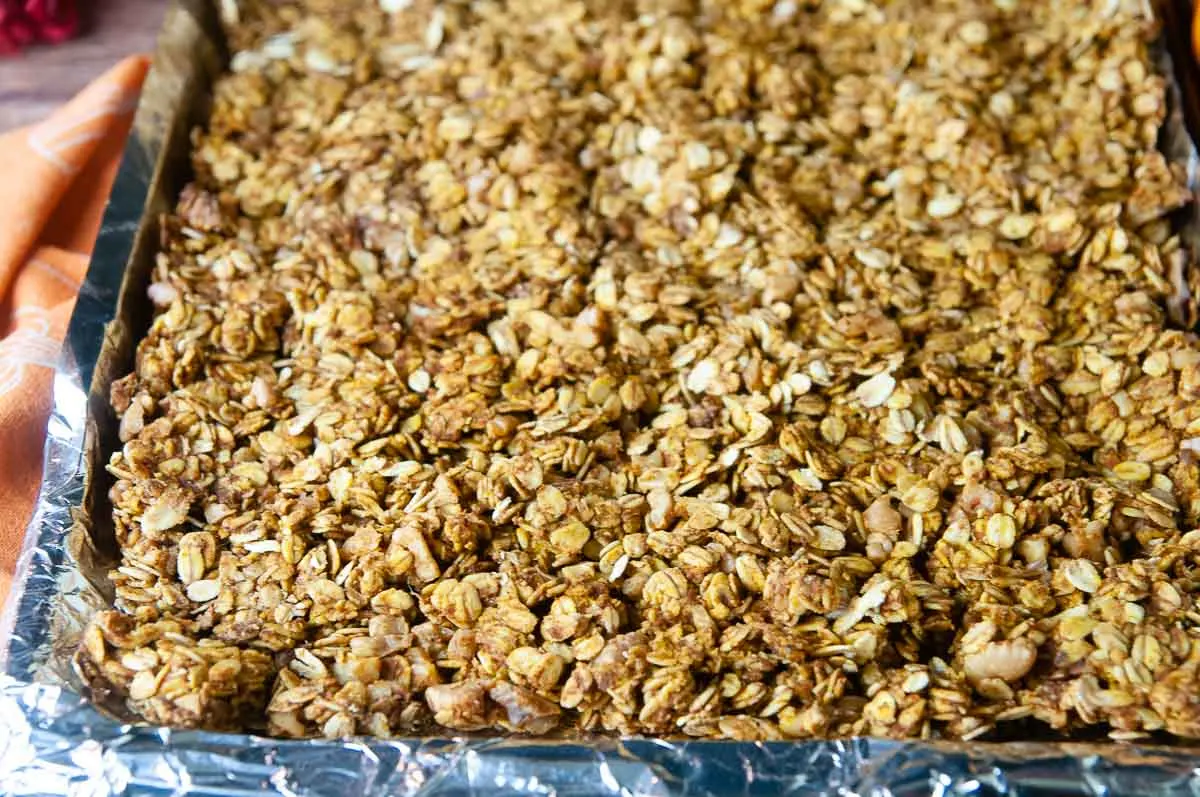 Spread the granola on a sheet pan lined with aluminum foil and sprayed with nonstick spray.