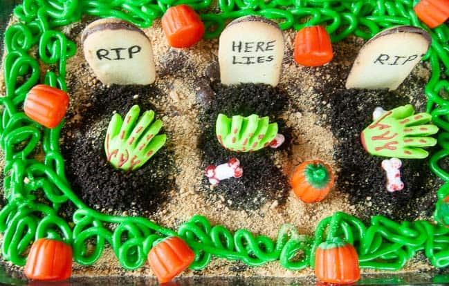 Spooky Graveyard Brownies are a fun food craft to do with the kids this Halloween. Cookies become tombstones and cookie crumbs, spooky sprinkles and edible zombie hands act as decorations.