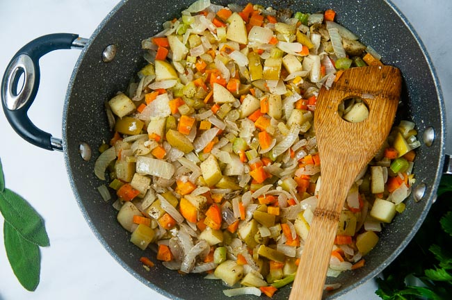 A large pan full of equal parts carrots, celery, onions, and apples that have been sauteed 