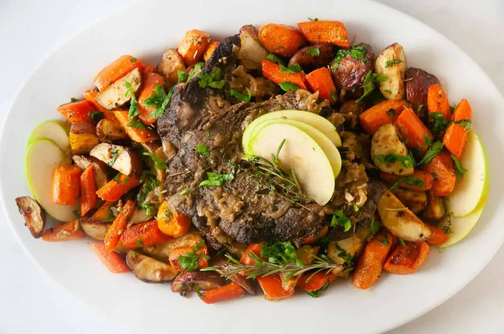 A platter of roast beef served on a white plate is easy to make thanks to the Instant Pot. 